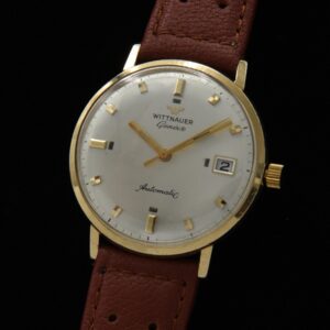 1960s Wittnauer 14k solid-gold dress watch with original dial, baton hands, mixed-shape markers, and serviced automatic winding movement.