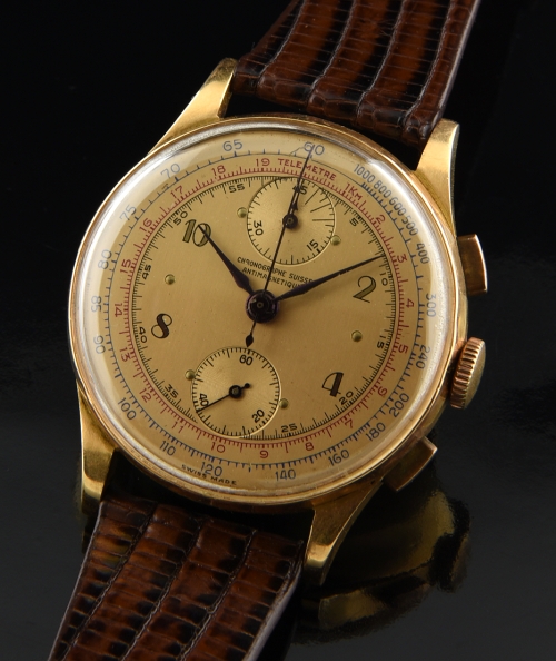 1940s Chronographe Suisse 18k rose-gold chronograph watch with original bezel, salmon dial, Arabic numerals, and Venus 170 manual movement.