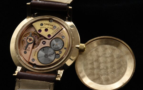 1959 Omega 9k solid-gold watch with original case, restored dial, Dauphine hands, markers, signed winding crown, and caliber 510 movement.