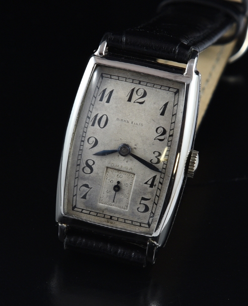 1935 Omega Birks Ellis kalonium watch with original dual-name dial, tonneau-shaped case, hands, and clean, accurate manual winding movement.
