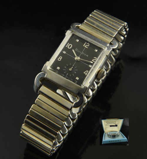 1960 Bulova 10k white-gold-filled watch with original black dial, box, case, bull-horn lugs, bracelet, and cleaned manual winding movement.