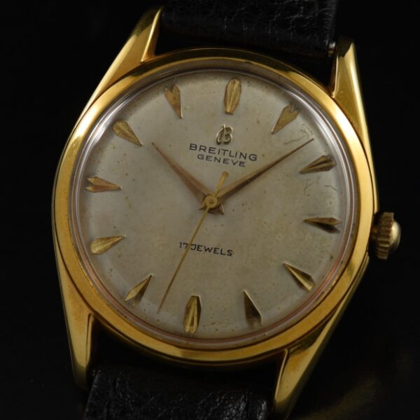 1960s Breitling dress watch with original gold-plated steel back, dial, raised Arabic markers, Dauphine hands, and manual winding movement.