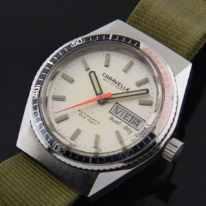 1970s Caravelle Set-O-Matic Dual-Day stainless steel watch with original angled lugs, turning bezel, dial, and quick-set day-date feature.