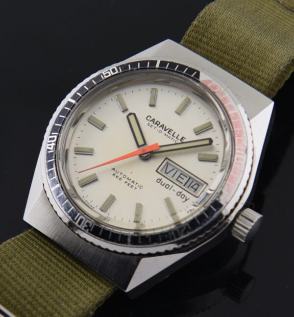 1970s Caravelle Set-O-Matic Dual-Day stainless steel watch with original angled lugs, turning bezel, dial, and quick-set day-date feature.