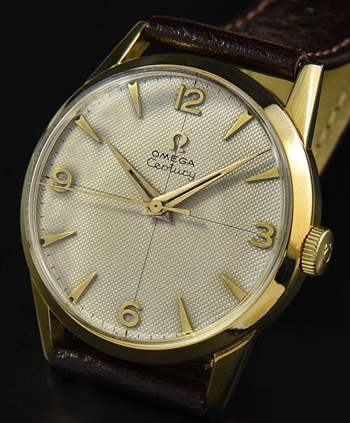 1953 Omega Century gold-filled watch with original honeycomb dial, Arabic numerals, arrow markers, and cleaned caliber 283 manual movement.