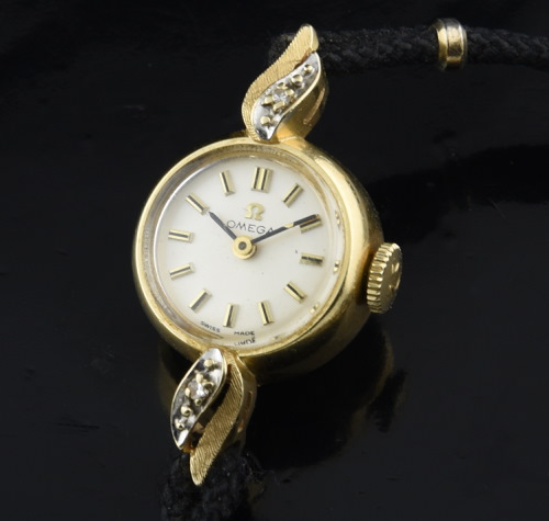 1950s Omega 14k solid-gold dainty ladies cocktail watch with original diamond bezel, correct winding crown, and cleaned, accurate movement.