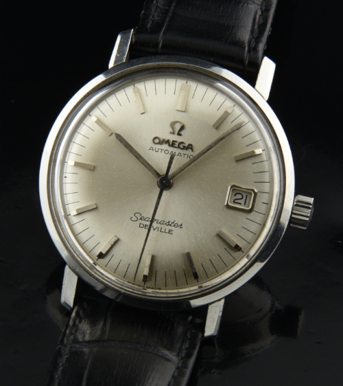 1960s Omega Seamaster De Ville Date stainless steel watch with original silver dial, hash-printed minute markers, and automatic movement.