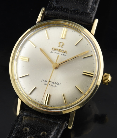 1970s Omega 34mm Seamaster 14k gold watch with original silver dial, hesalite crystal, winding crown, and clean automatic winding movement.