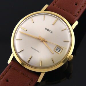 1960s Doxa 14k solid-gold watch with original case, narrow bezel, all-dial appearance, hands, and automatic movement with a date feature.