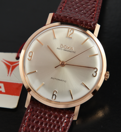 Vintage 1960s Doxa 34.5mm 18k solid rose gold watch with original case, dial, hands, hang tag, and cleaned automatic winding movement.