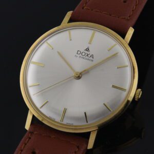 Doxa 34mm Ultra-Thin solid 14k gold watch with original crisp appearance, dial, markers, hands, case, and Synchron manual winding movement.