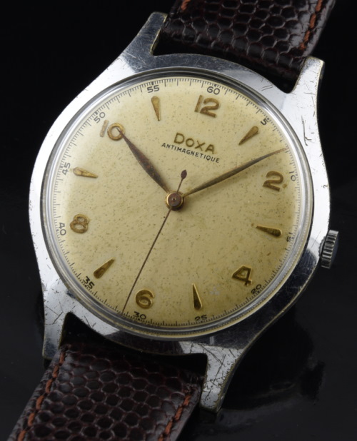 1940s Doxa Antimagnetic chrome-plated watch with original balanced dial, leaf hands, Arabic markers, sweep seconds, and cleaned movement.