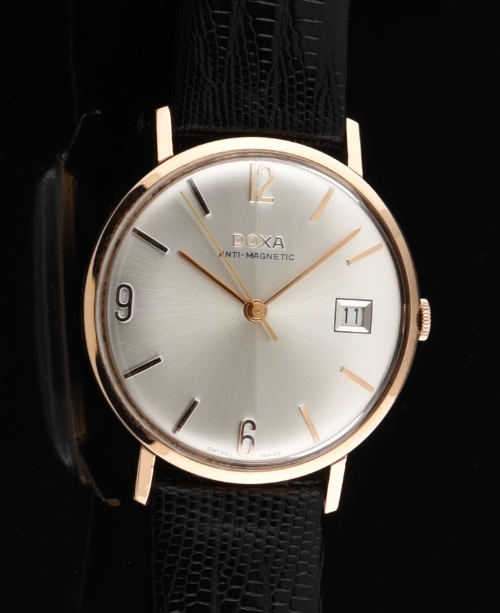 1970s Doxa 14k solid-rose-gold watch with original dial, Arabic numerals, baton markers, date aperture, and cleaned manual winding movement.