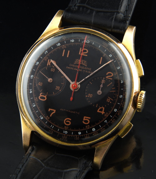 1950 Egona 18k rose-gold chronograph watch with original glossy-black dial, Arabic numerals, hands, and manual winding Landeron movement.
