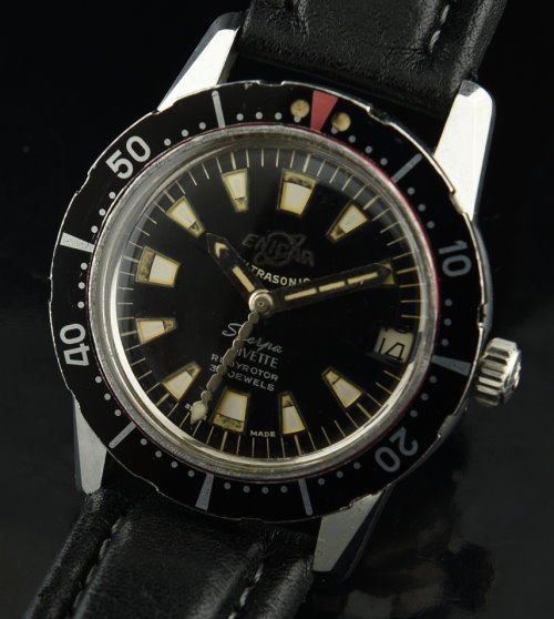 1960s Enicar Divette stainless steel dive watch with original hands, trapezoid markers, black dial, bezel, and automatic winding movement.