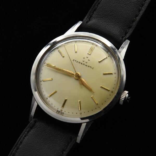 1960s Eterna-Matic 33mm Swiss stainless steel watch with original dial, gold markers, Dauphine hands, screw-back case, and winding crown.