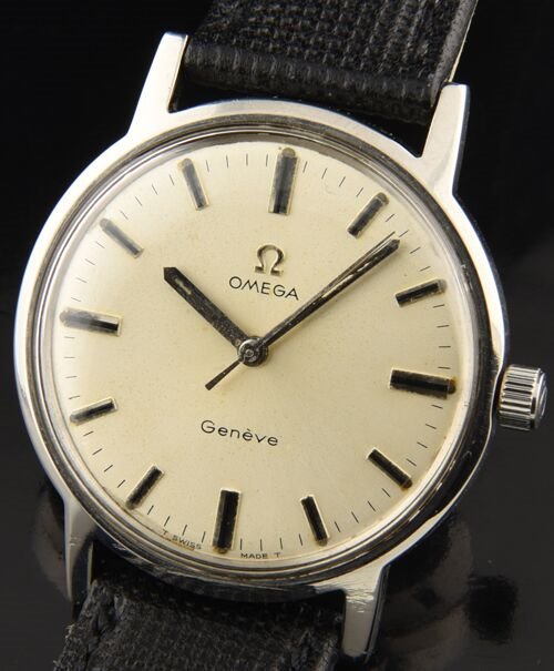 1970 Omega Geneve stainless steel watch with original case, winding crown, silver dial, hands, and caliber 601 manual winding movement.
