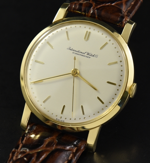 1960s IWC 18k solid-gold watch with original case, dial, raised baton markers, needle hands, and clean caliber 401 manual winding movement.