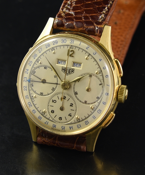 1950s Heuer Triple Date 18k solid-gold chronograph watch with original restored dial, hands, case, and Valjoux 72C manual winding movement.