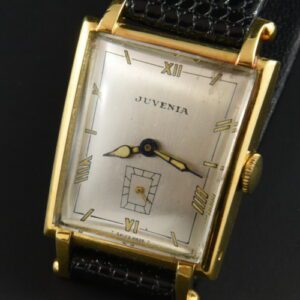 1950s Juvenia 18k solid-gold watch with original grasshopper-style case, ball-tipped lugs, restored dial, and clean manual winding movement.