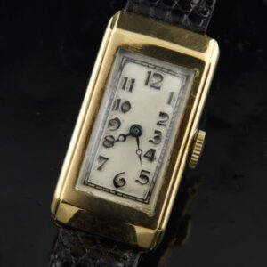 1930s Swiss 9k solid-gold ladies rectangular watch with original dial, hands, stylized raised numerals, and cleaned manual winding movement.