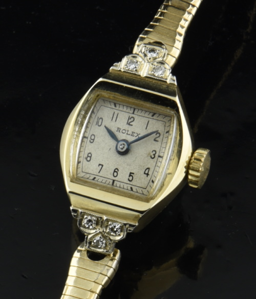 1940s Rolex 27mm 14k gold ladies cocktail watch with original dial, case, six authentic diamonds, bracelet, and fine Tudor-signed movement.