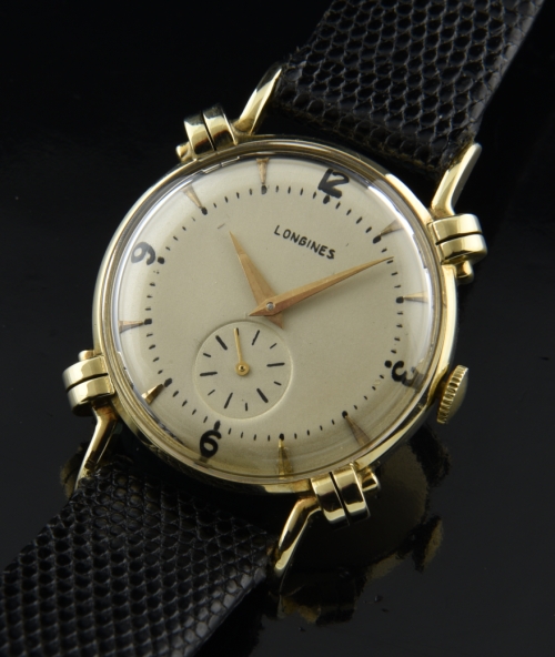 1954 Longines 14k solid-gold watch with original bombe lugs, restored dial, markers, Dauphine hands, and cleaned manual winding movement.
