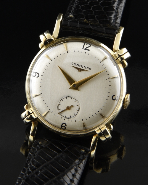1950 Longines 14k gold watch with original bombe lugs, restored dial, raised markers, Dauphine hands, and cleaned manual winding movement.