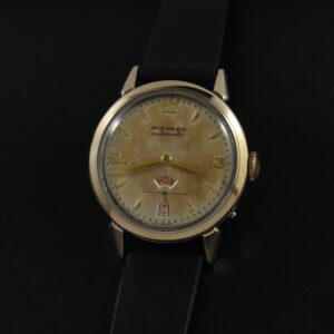 1950s Movado 33mm 14k gold-capped watch with original case, bezel, raised numerals, red day/date aperture, and bumper automatic movement.