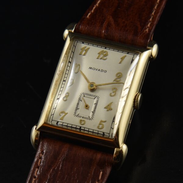 1940s Movado 23x36mm watch with a restored original dial, 14k gold case, manual winding movement, and Breguet-styled gold-toned numerals.