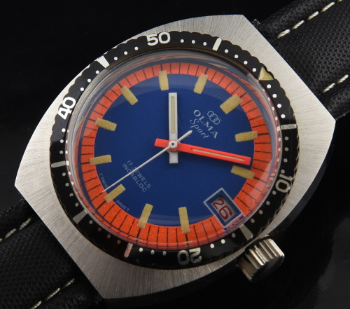 1970s Olma 42.5mm chrome and steel dive watch with original orange/blue dial, turning bezel, baton hands, and clean manual winding movement.