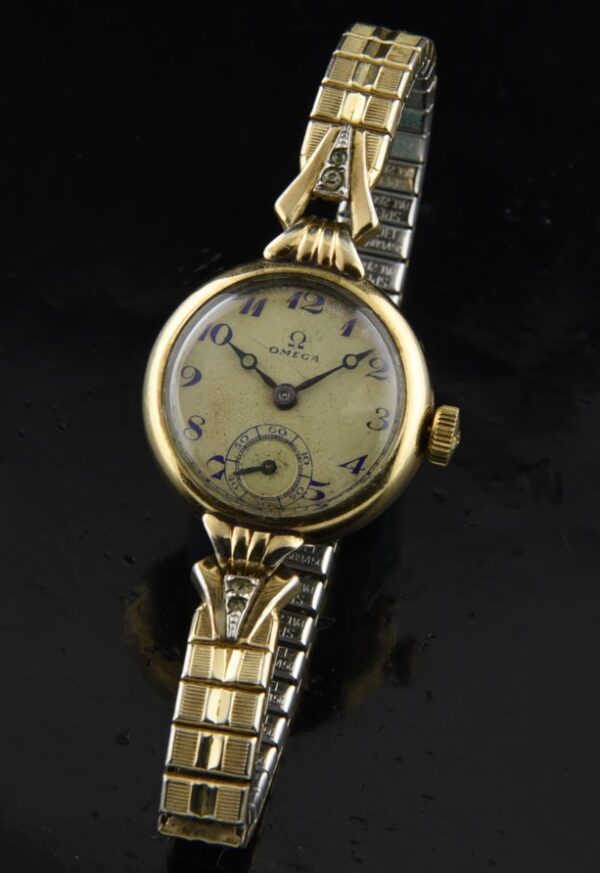 1950s Omega 21.5mm gold-filled ladies cocktail watch with original case, bracelet, spare stretch band, and cleaned manual winding movement.