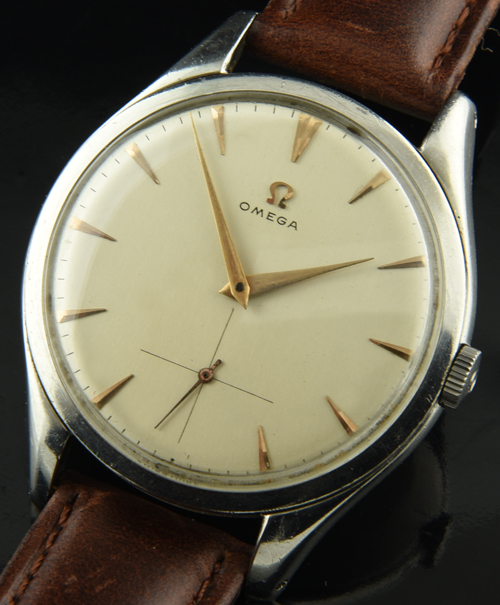 1952 Omega stainless steel dress watch with original dial, gold-toned hands, arrow markers, and cleaned caliber 266 manual winding movement.