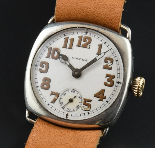 1917 Omega 32mm WW1-era sterling silver trench watch with original cushion case, onion crown, porcelain dial, and manual winding movement.