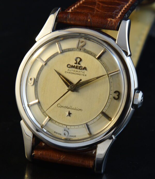 1960 Omega Constellation stainless steel watch with original two-tone rail dial, exlorer-style Arabic numerals, and caliber 551 movement.