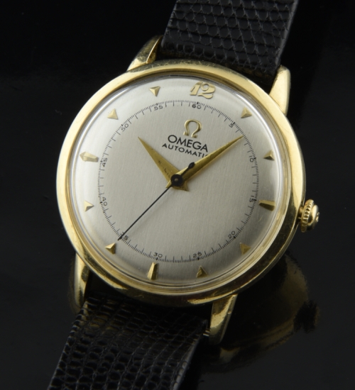 1949 Omega gold-filled watch with original case, winding crown, restored silver dial, and caliber 351 bumper automatic winding movement.