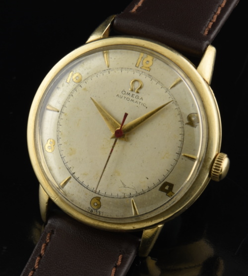1950 Omega 32mm gold-filled watch with original box, papers, silver dial, Dauphine hands, and cleaned caliber 351 bumper automatic movement.