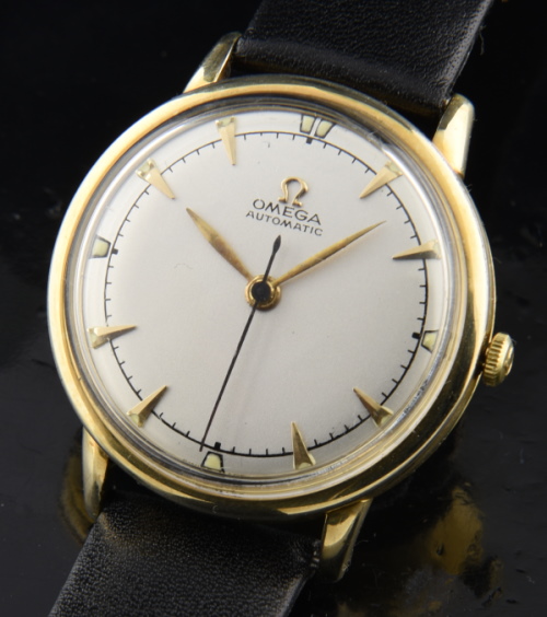 1956 Omega 32mm gold-filled watch with original raised arrow markers, restored dial, and accurately running bumper automatic movement.