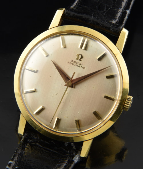 1958 Omega 34.5mm Calatrava 18k solid-gold watch with original Dauphine hands, gentle patina, case, narrow bezel, and caliber 501 movement.
