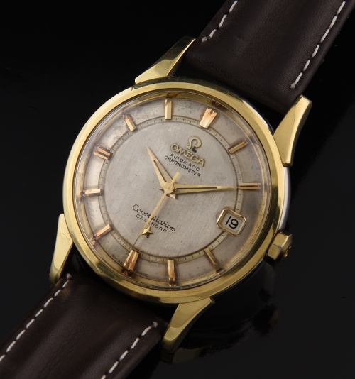 1960 Omega Constellation stainless steel watch with original rail dial, gold-toned markers, date aperture, and chronometer-grade movement.