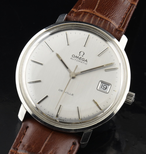 1970s Omega 36mm De Ville stainless steel watch with original narrow bezel, pewter dial, hands, crown, and clean automatic winding movement.