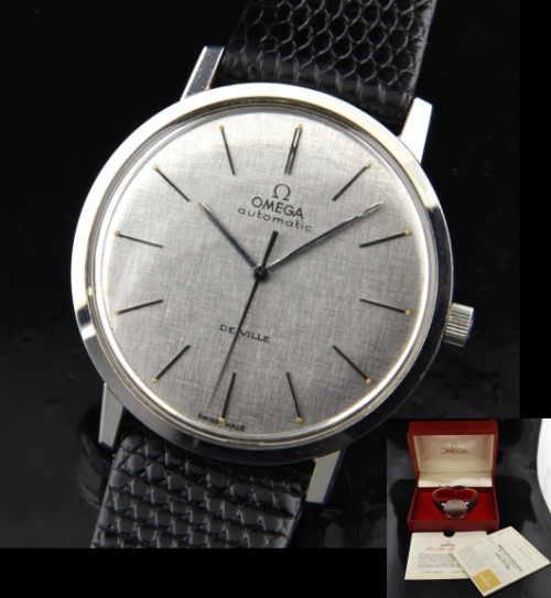 1971 Omega 34.5mm De Ville stainless steel watch with original pewrer-toned dial, hands, box, papers, and caliber 711 automatic movement.