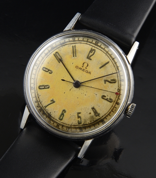 1940 Omega stainless steel WW2-era military watch with original needle hands, Arabic numerals, and rectangular manual winding movement.