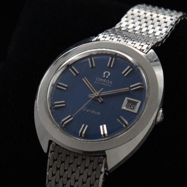 1970 Omega 37mm Geneve stainless steel watch with polished bezel, winding crown, rare blue dial, and caliber 565 automatic winding movement.