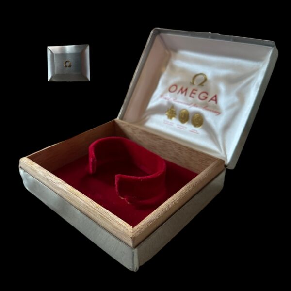 1960s 3.75x4.5" Omega box with a metal exterior and wood and velvet interior. Perfect for your 1960s vintage Omega.