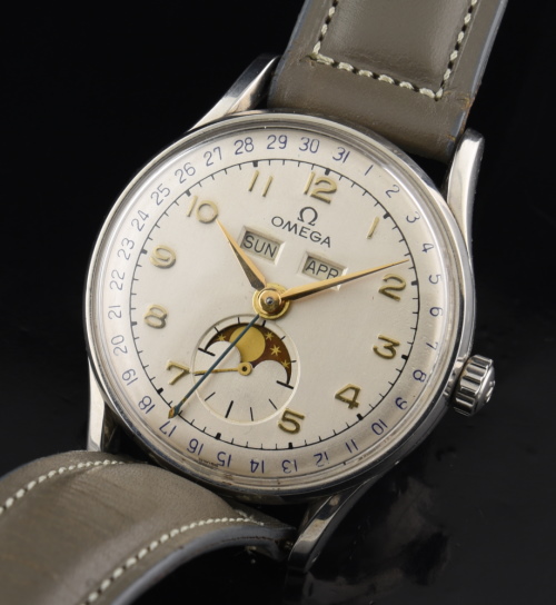 1946 Omega 34.5mm Triple Date Moonphase Cosmic stainless steel watch with original restored dial, painted aperture, and gold-toned markers.