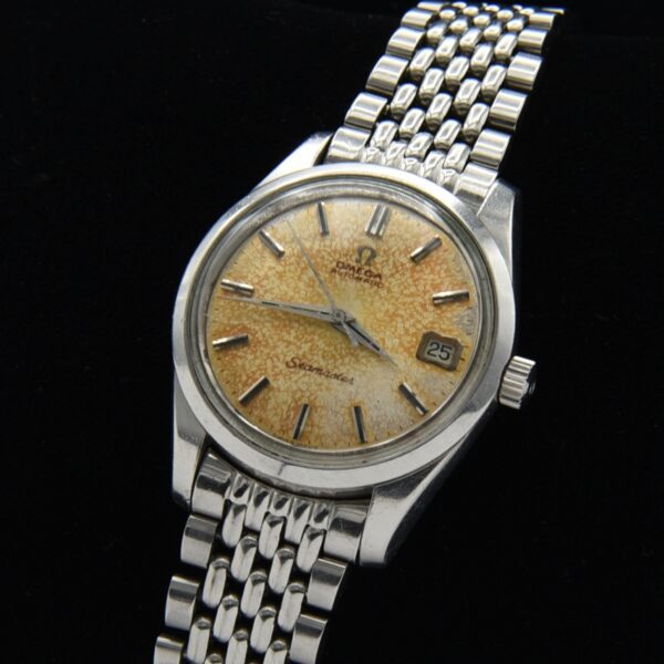1966 Omega Seamaster stainless steel watch with original Dauphine hands, screw-back case, beads-of-rice bracelet, and caliber 565 movement.