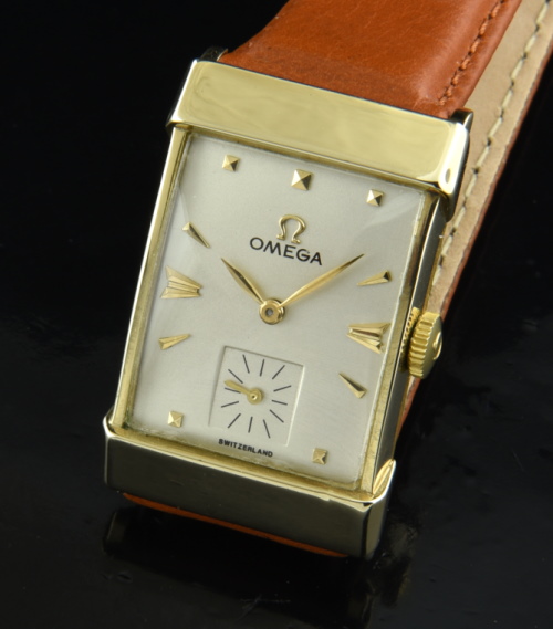 1947 Omega 34.5mm 14k solid-gold rectangular watch with original restored dial, hands, pyramid/arrow markers, and manual winding movement.