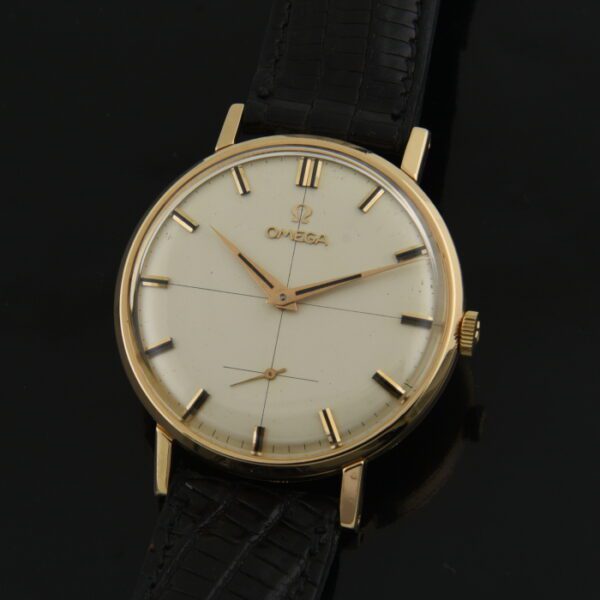 1960 Omega 36mm 18k rose gold dress watch with original case, winding crown, dial, hands, and cleaned manual winding caliber 267 movement.