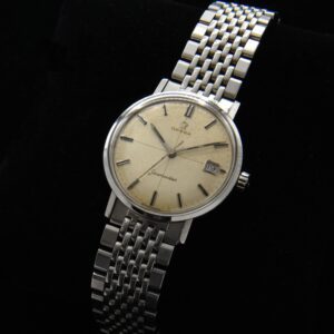 1960s Omega 34mm Seamaster stainless steel watch with original dial, black inset markers and hands with date aperture, and hesalite crystal.